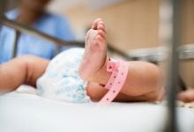 view of new born baby's foot with hospital tab on ankle