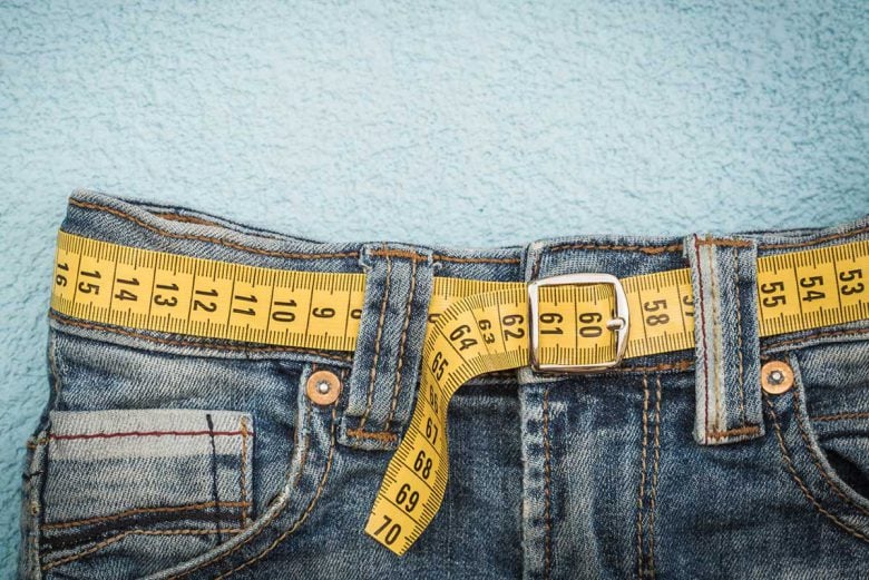 pair of jeans with a tape measure as a belt
