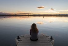 Woman looking out over a lake