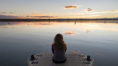 Woman looking out over a lake