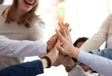 Group of employees giving each other high-five