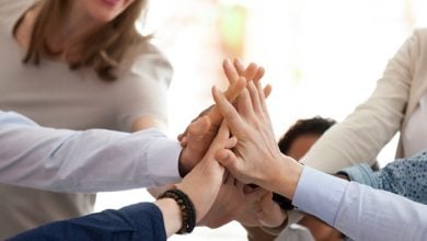 Group of employees giving each other high-five