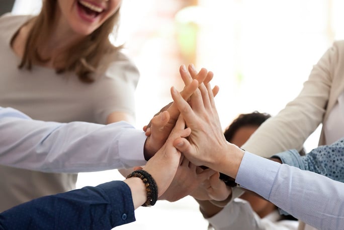 Group of employees giving each other high-five