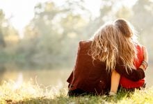 What it means to forgive - two women sitting on grass together