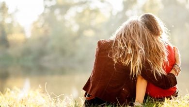 What it means to forgive - two women sitting on grass together