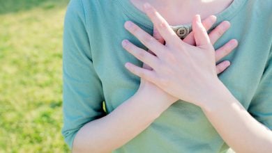 Does Energy Healing Really Work? Woman with hands over heart