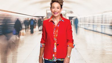 Carol walking through busy hallway