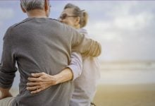 Mature couple hugging on the beach