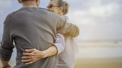 Mature couple hugging on the beach