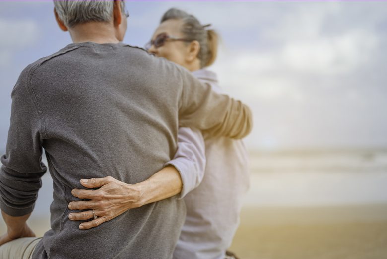 Mature couple hugging on the beach