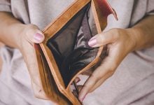 Woman opening up her empty wallet