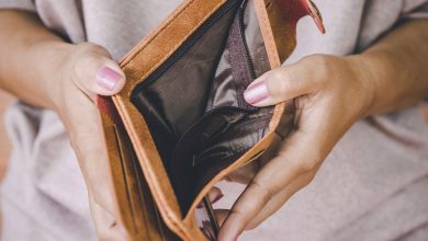 Woman opening up her empty wallet