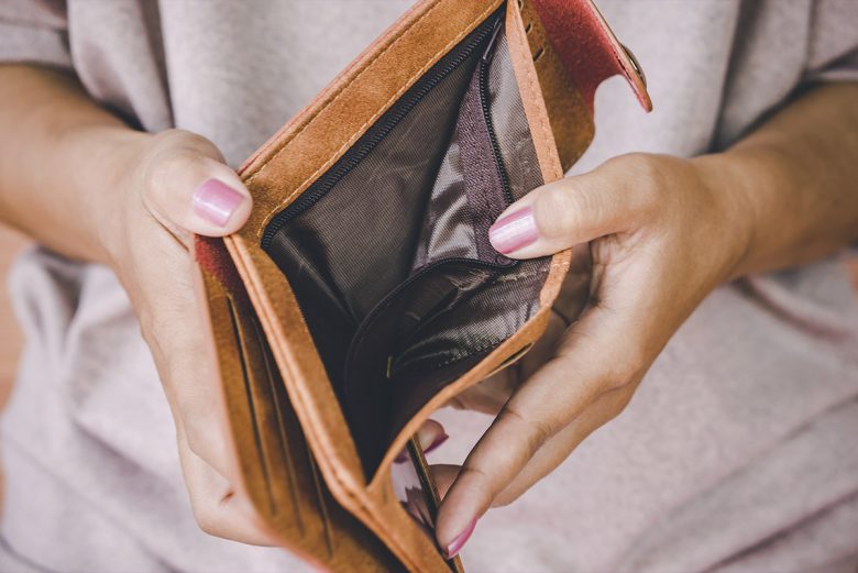 Woman opening up her empty wallet