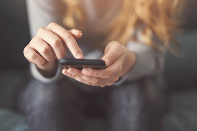 Do you need a social media cleanse? woman holding phone