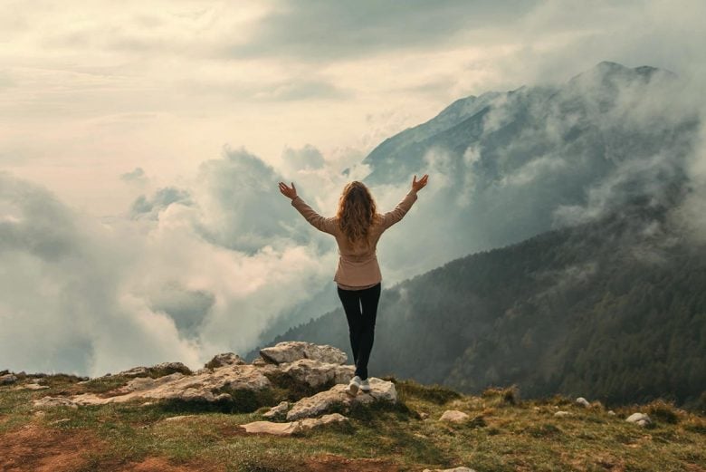 Woman looking out over mountains - how to stop self-sabotage