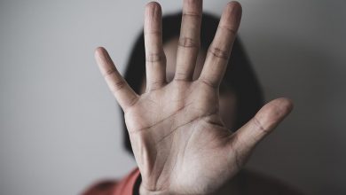 Woman holding hand in front of face - resistance to doing healing work