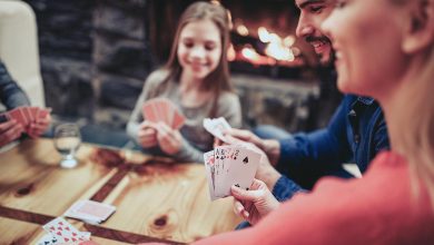 Family gathered around table playing cards - hidden blessings of 2020