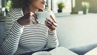 Woman sitting in coffee shop looking out the window