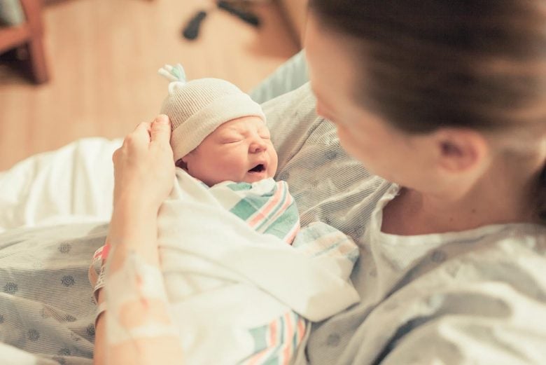 Mother holding newborn baby - how birth can lead to a peaceful birth