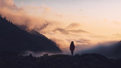 How to recover and fully heal after divorce - woman standing in nature among mountains