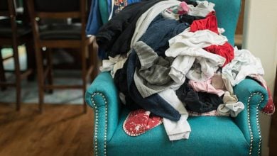 Messy clothes on green armchair