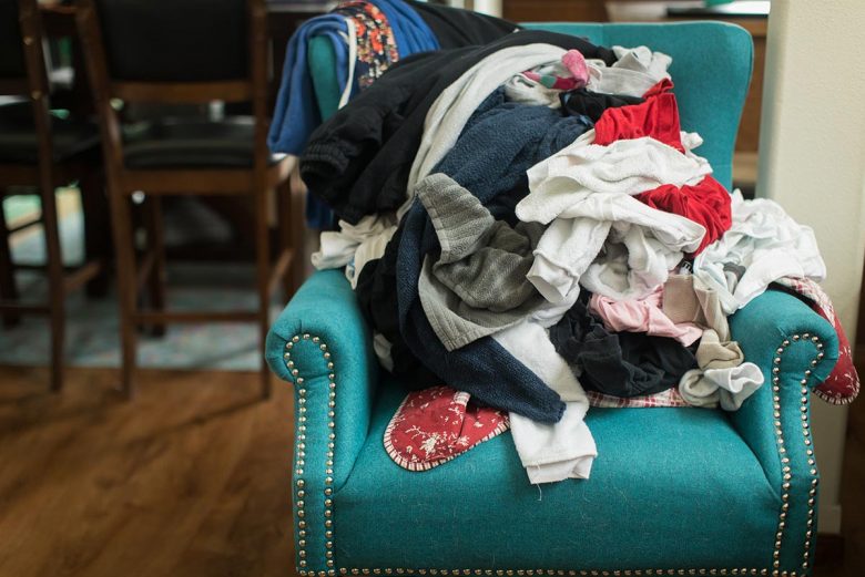 Messy clothes on green armchair