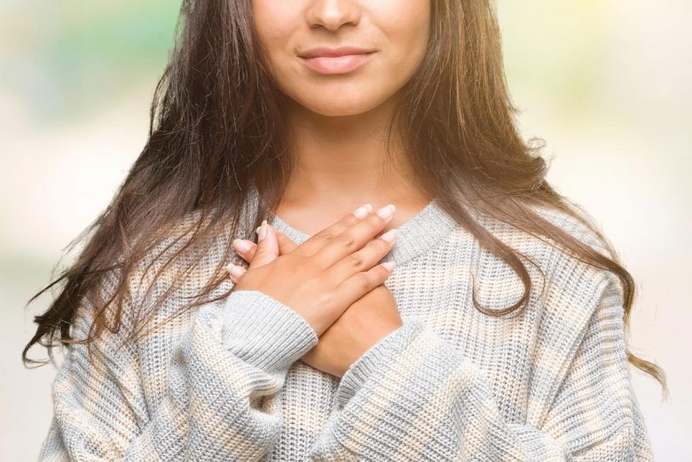 Woman with hands over heart