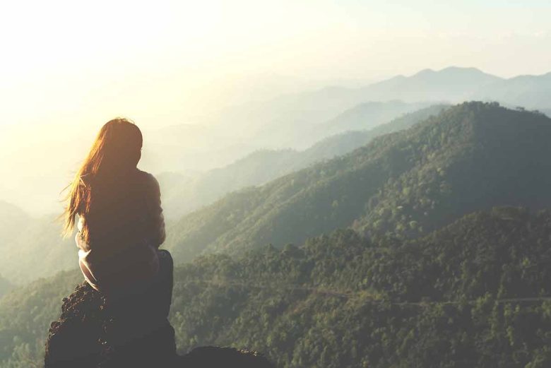 Woman looking out into distant mountains