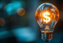 Glowing light bulb with a dollar sign inside