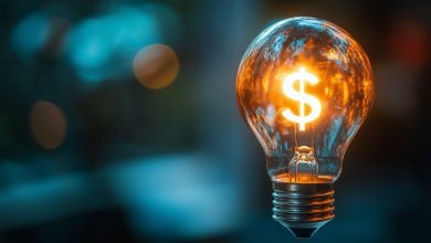 Glowing light bulb with a dollar sign inside