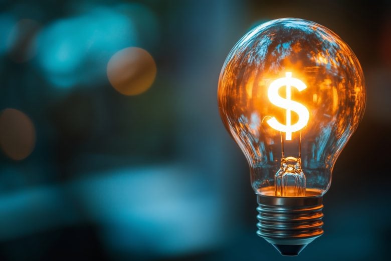 Glowing light bulb with a dollar sign inside